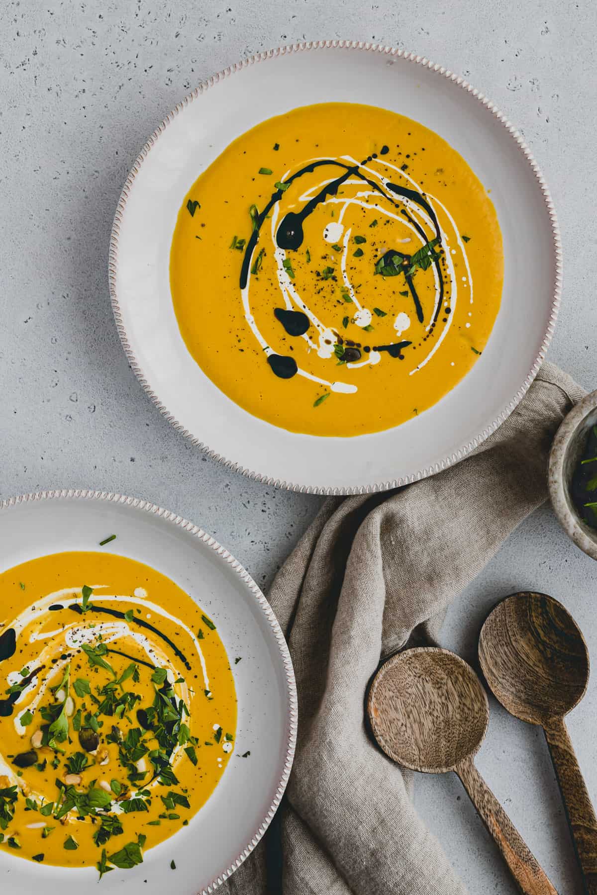 red kuri squash soup in two soup plates