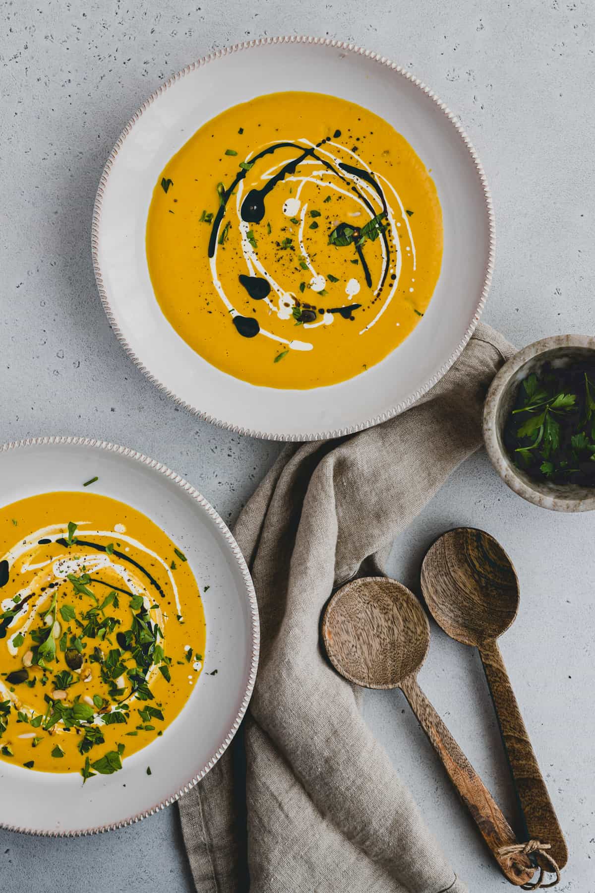 soup bowls filled with red kuri squash soup