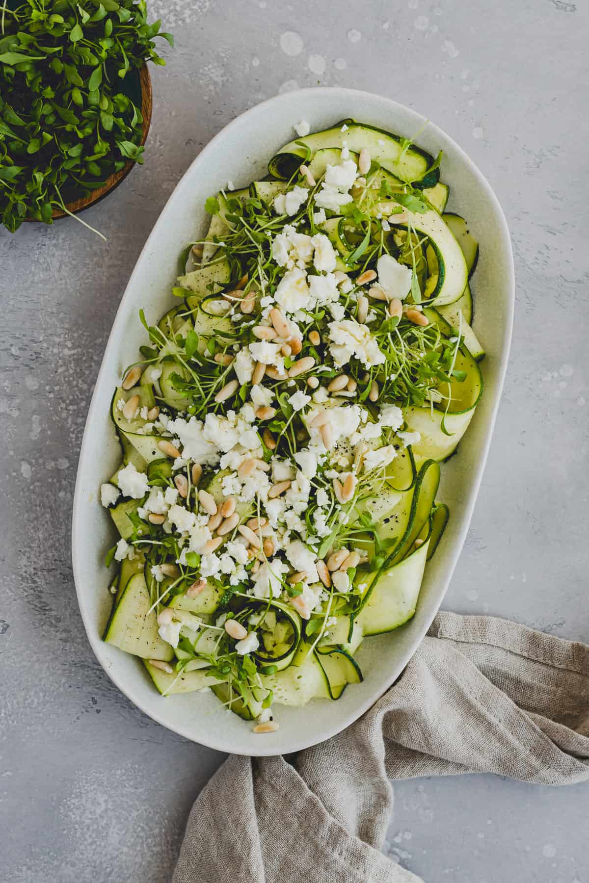 raw zucchini salad served on a platter