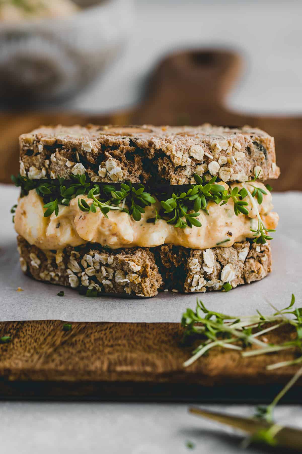 creamy egg sandwich on a chopping board