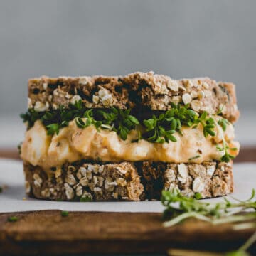 egg salad sandwich with garden cress on a chopping board