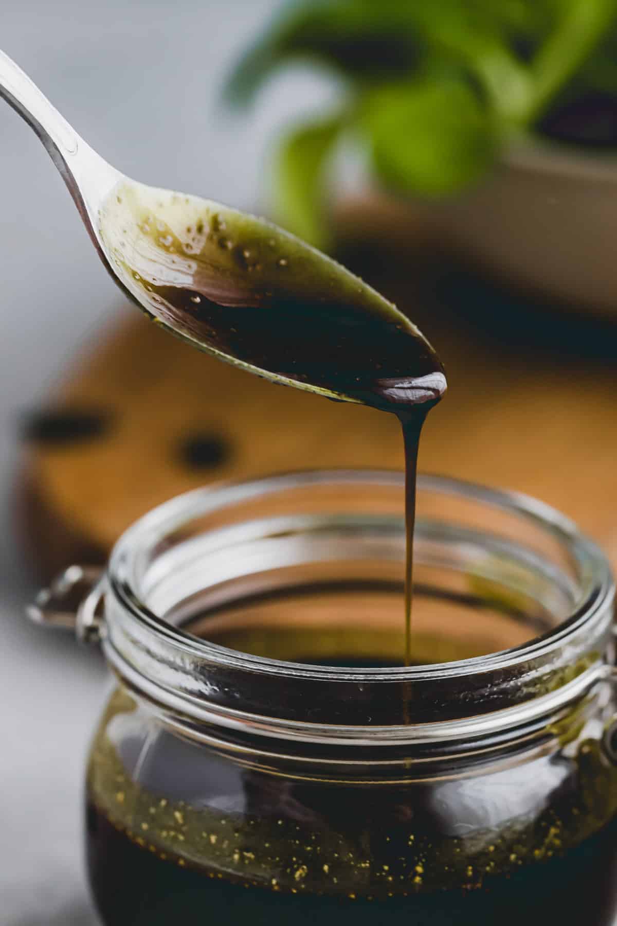 pumpkin seed oil dressing drizzling from a teaspoon