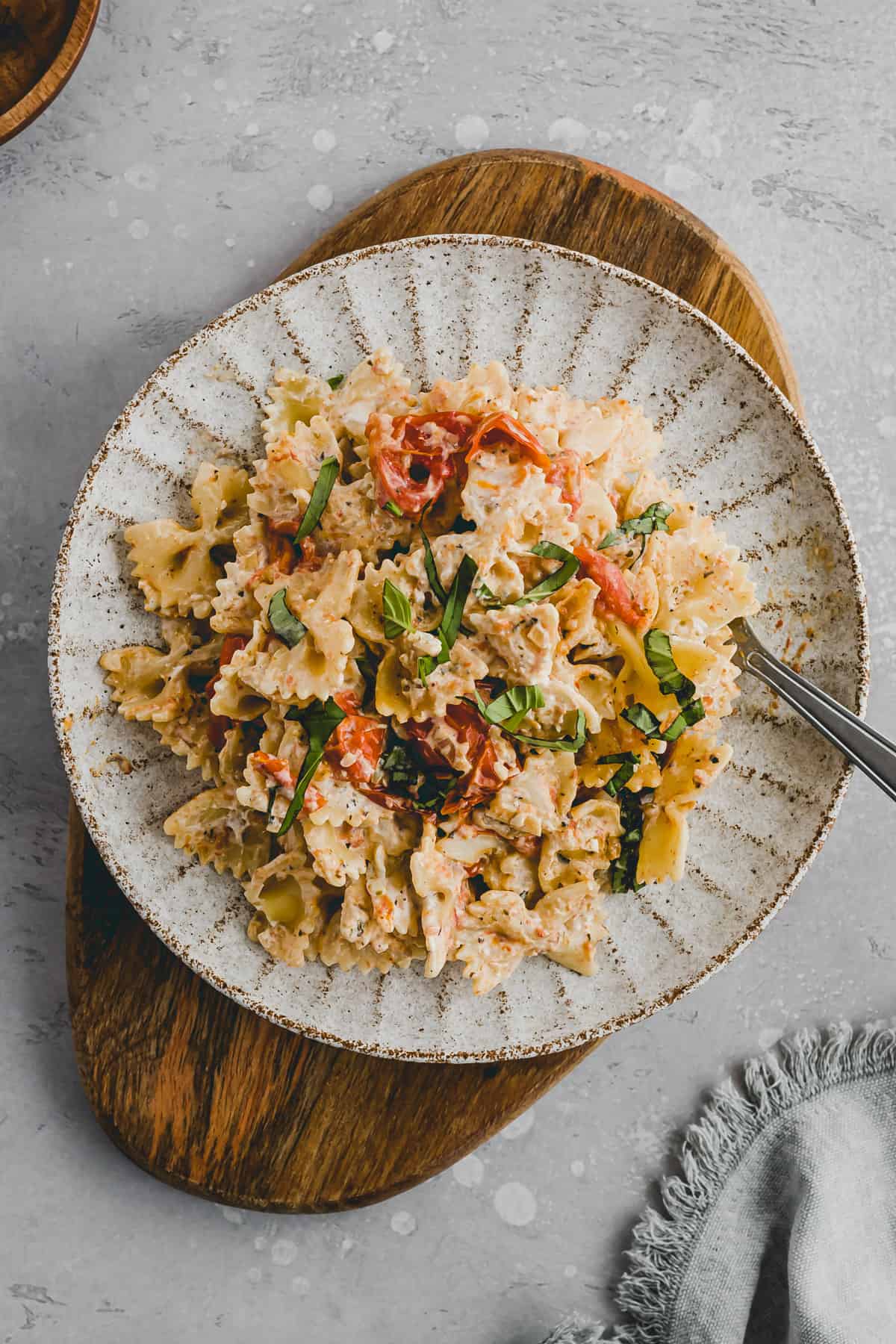 Baked Cream Cheese Pasta with tomatoes on a plate