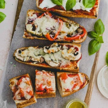 french bread pizza served on a wooden platter