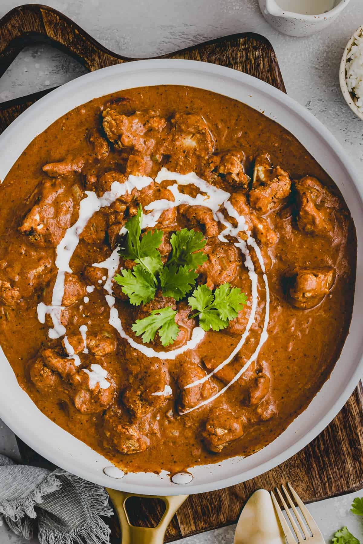 cauliflower tikka masala in a skillet topped with cilantro