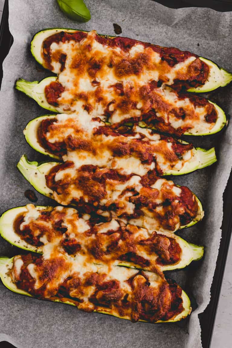 Vegetarian Stuffed Zucchini with vegan mince on a baking sheet