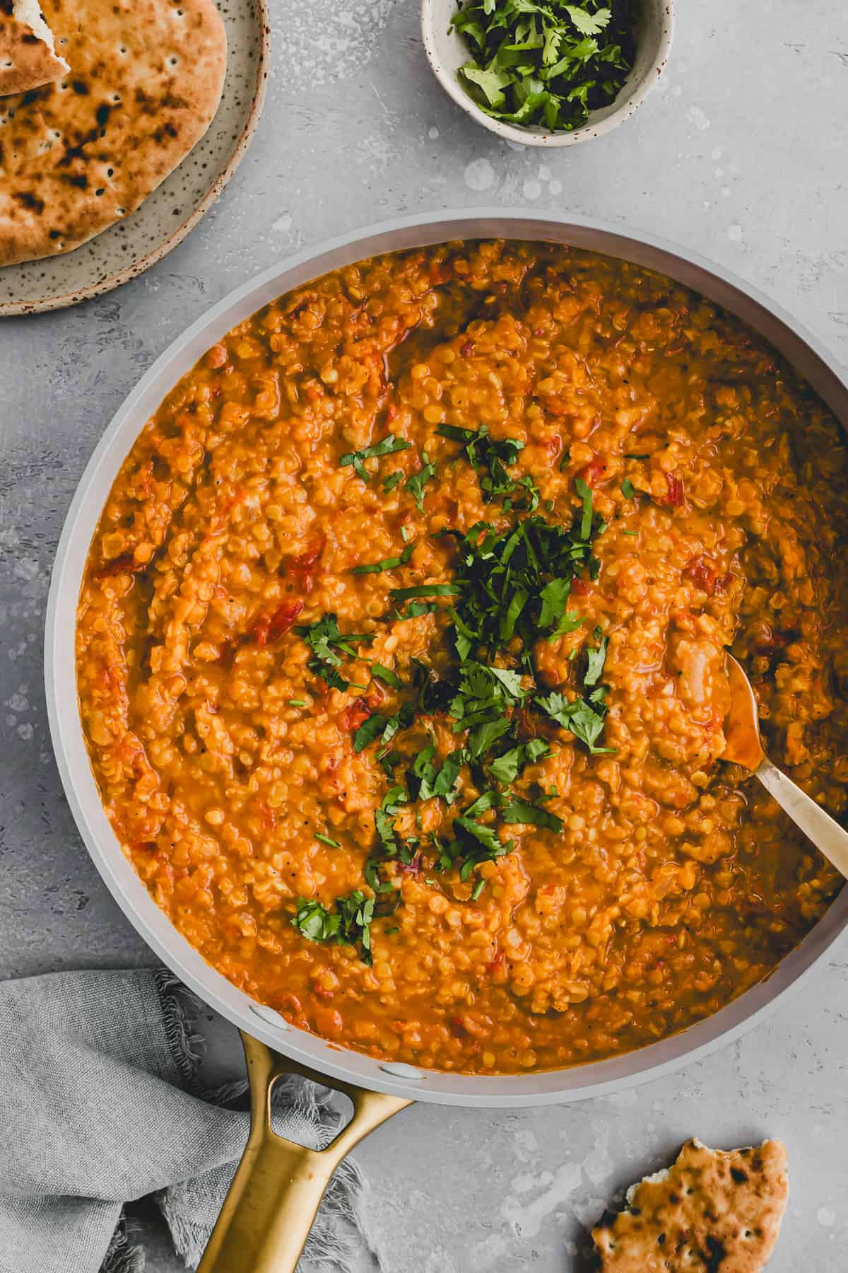 indian red lentil dal served with naan bread