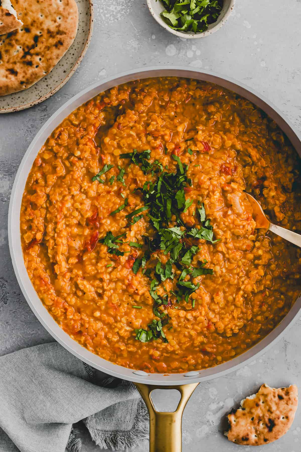 red lentil dal in a skillet topped with cilantro