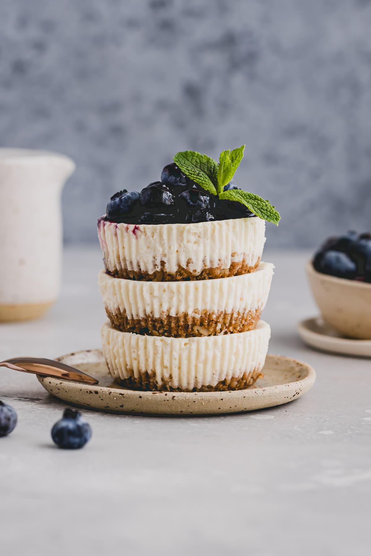 stacked mini cheesecakes bites topped with blueberries and mint