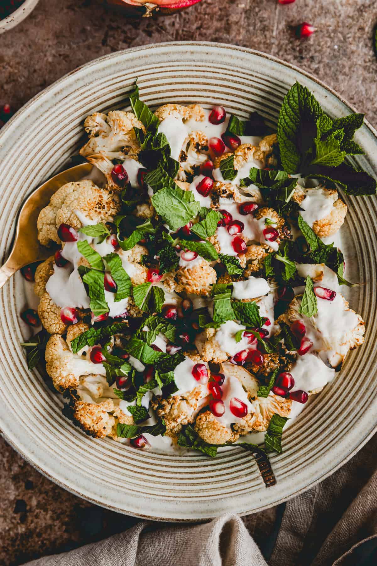 roasted cauliflower with tahini, pomegranate, and fresh mint