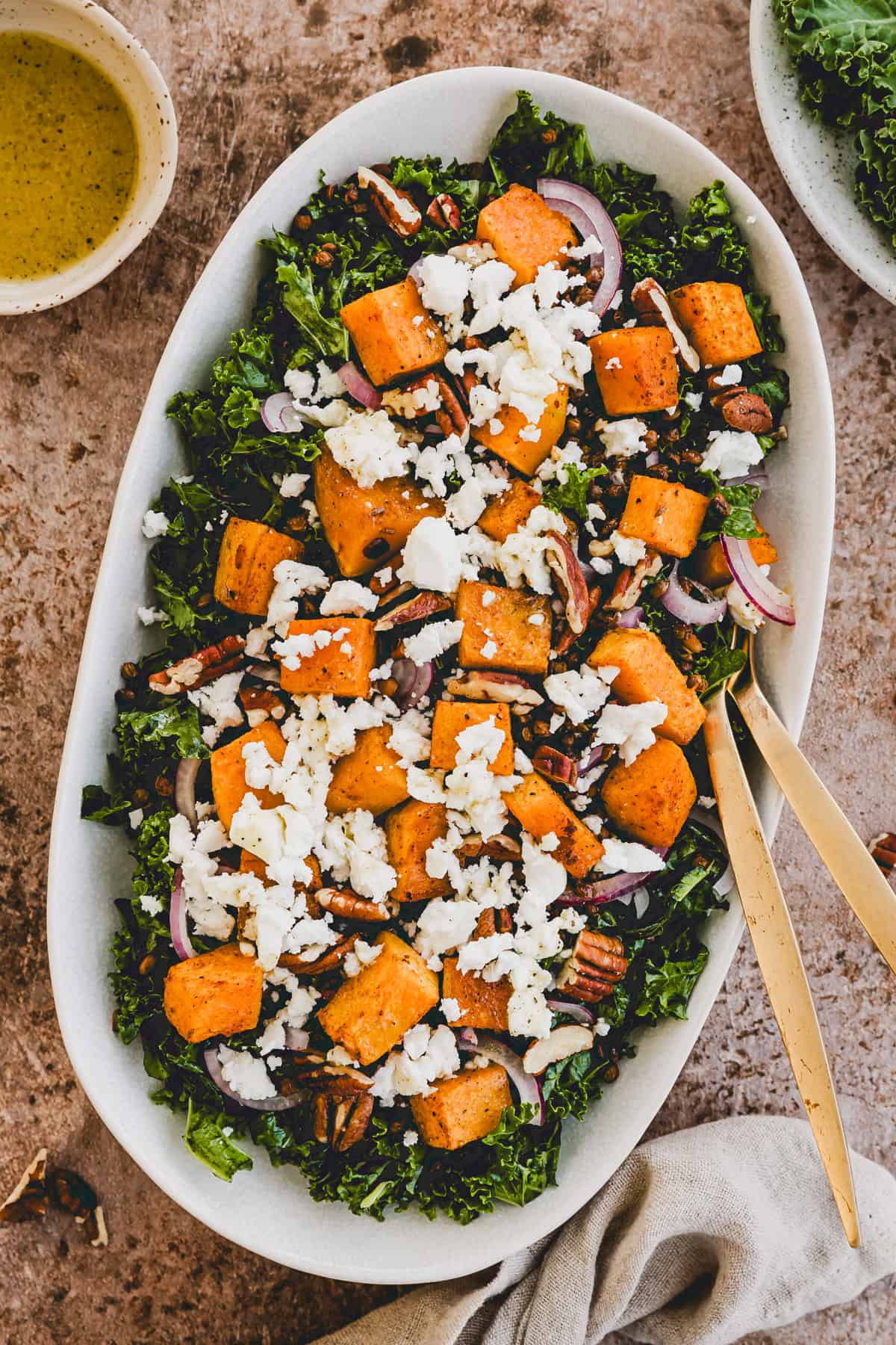 roast pumpkin salad with kale, lentils, and feta cheese on a plate