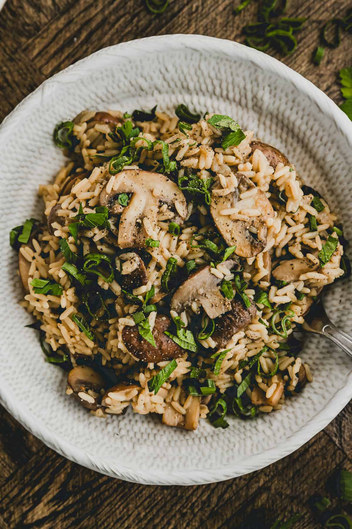 One Pot Mushroom Rice in a bowl garnished with parsley