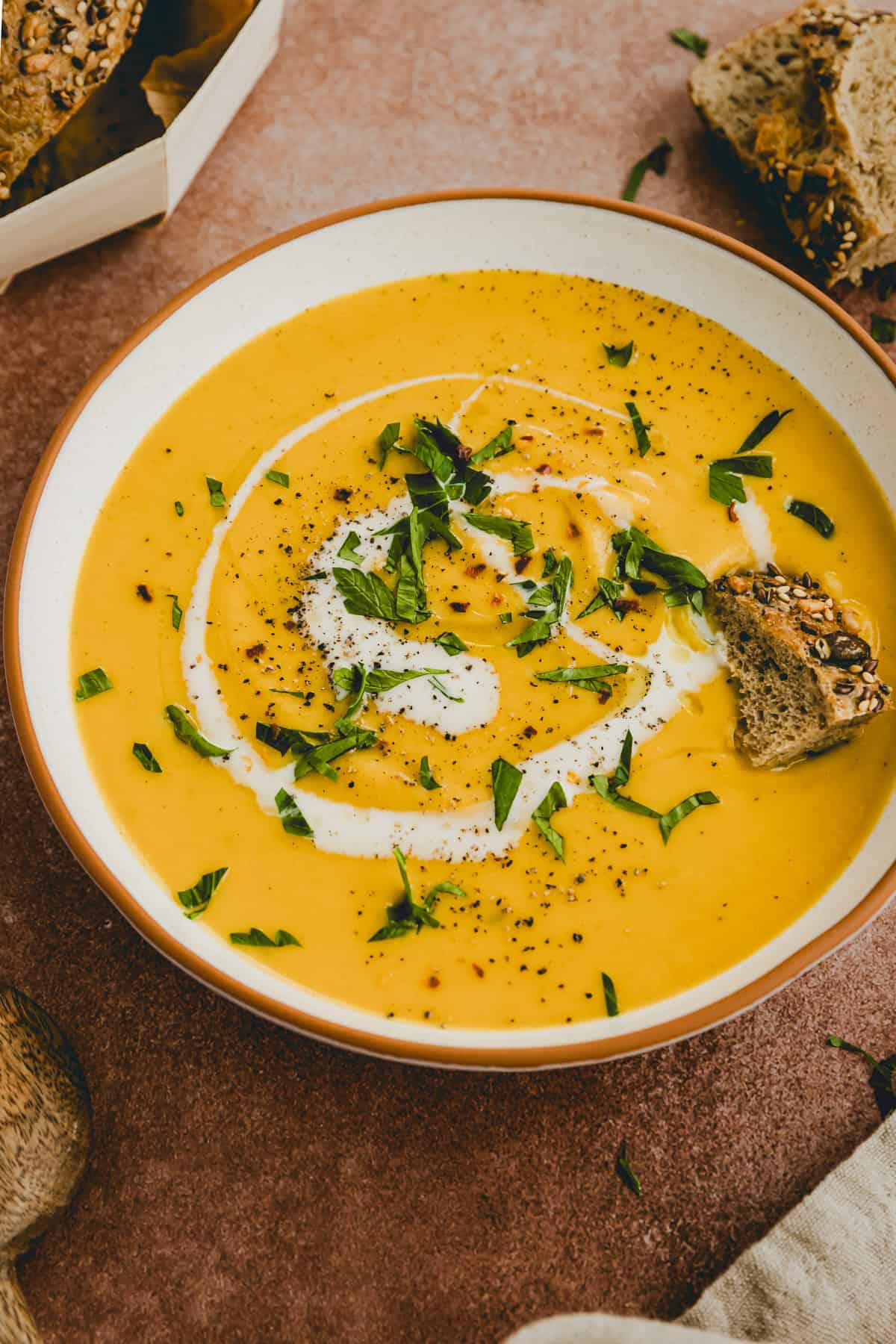 soup with red lentils served in a bowl garnished with parsley