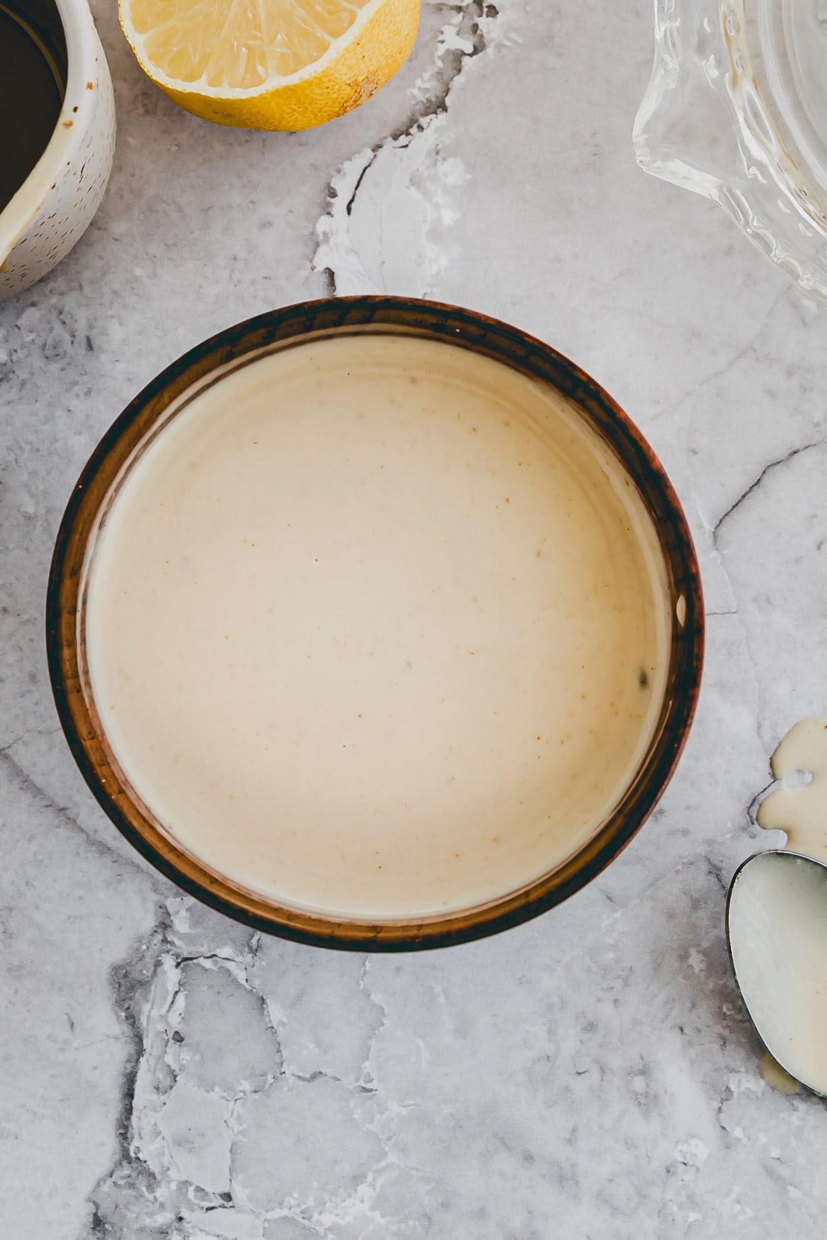 homemade tahini sauce in a small wooden bowl