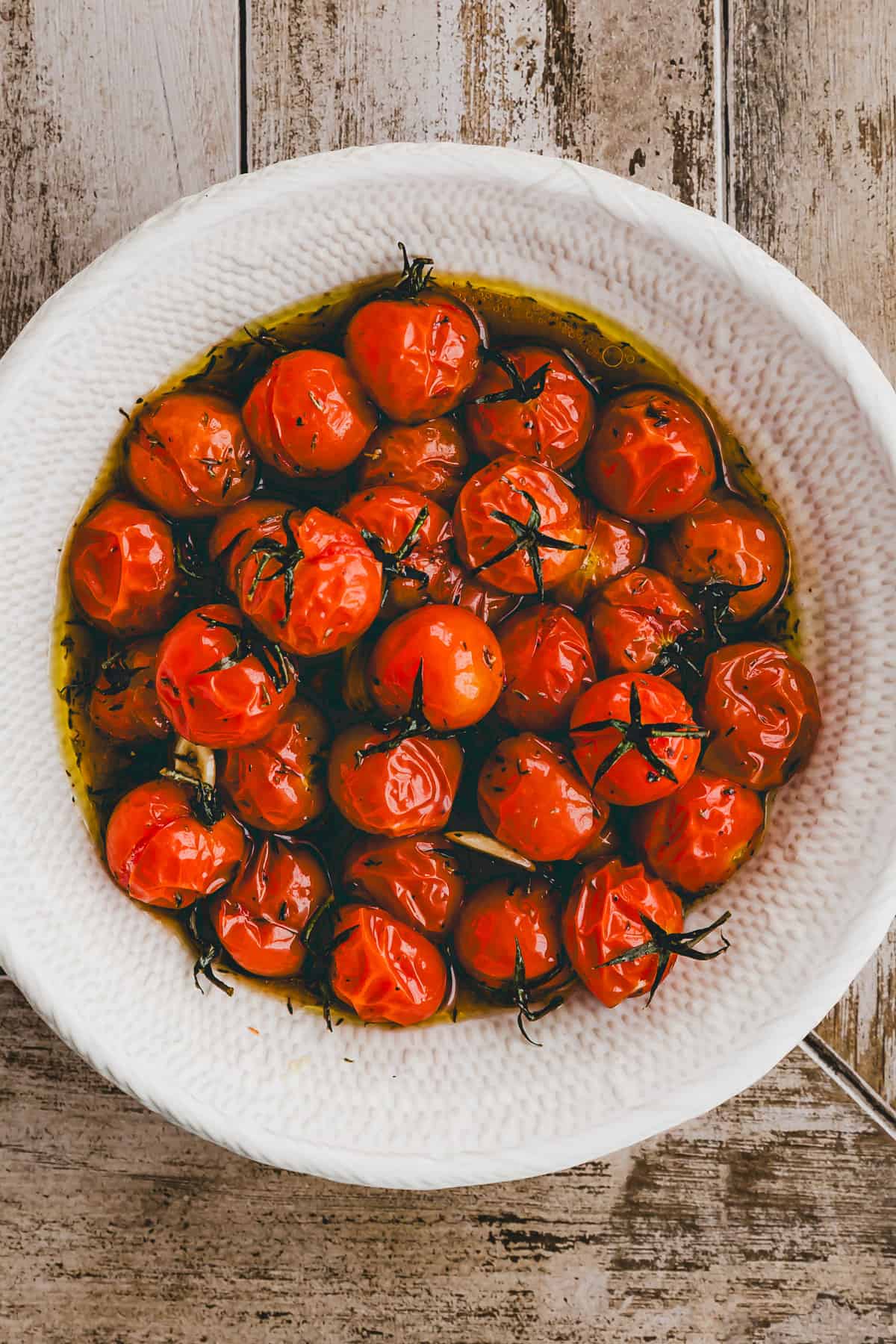 roasted cherry tomatoes in a white bowl