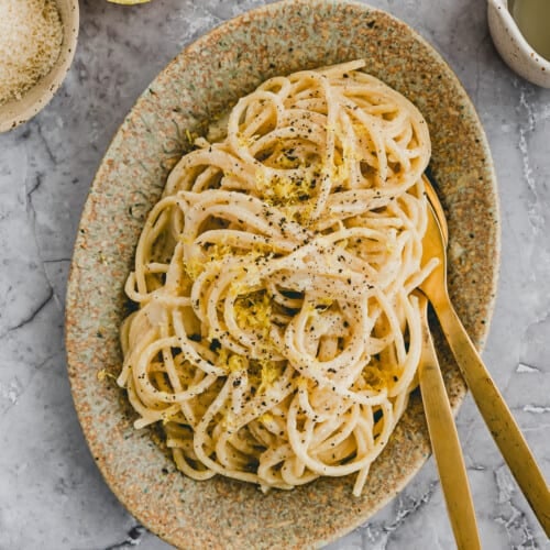 pasta al limone auf einem teller neben einer zitrone