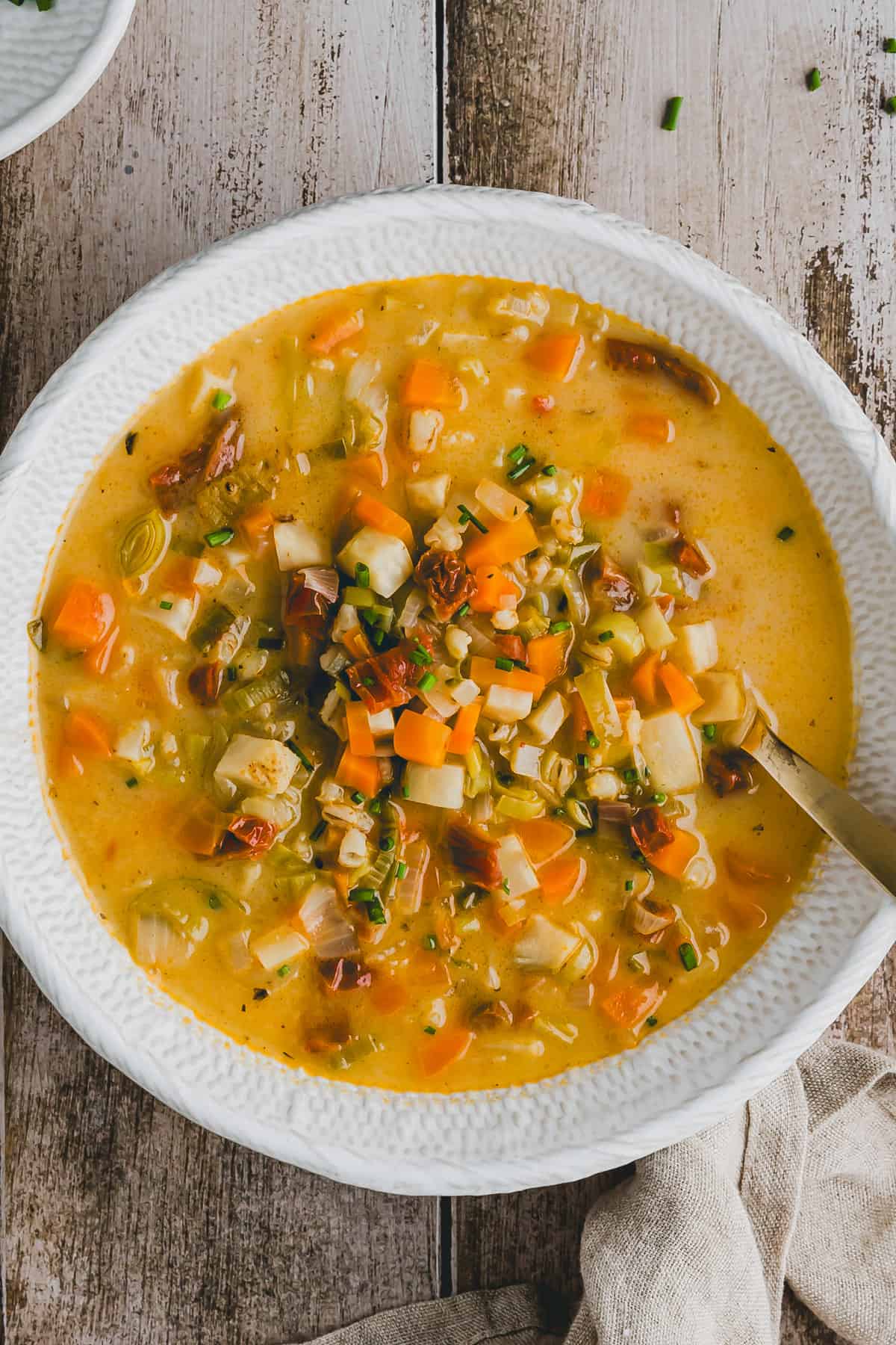 vegetable pearl barley soup in a white bowl