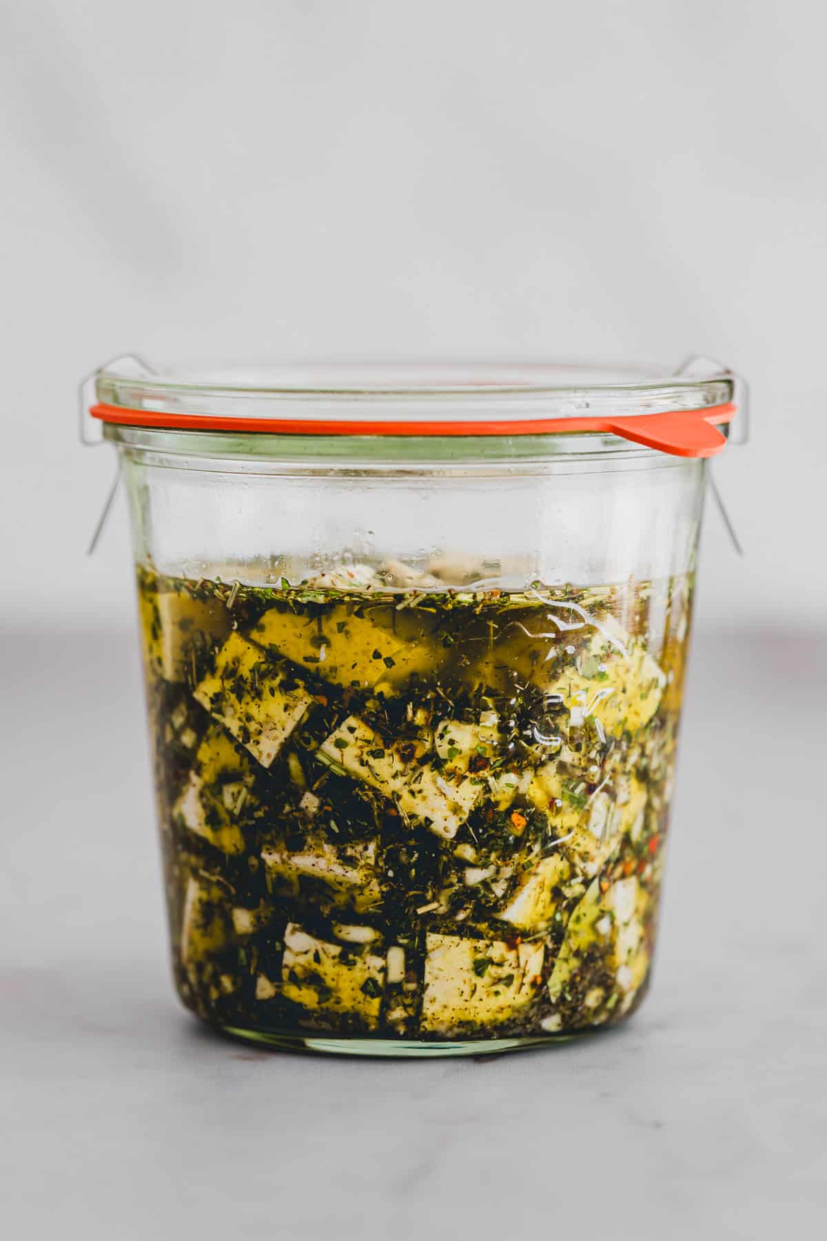 tofu feta cheese in a jar with olive oil