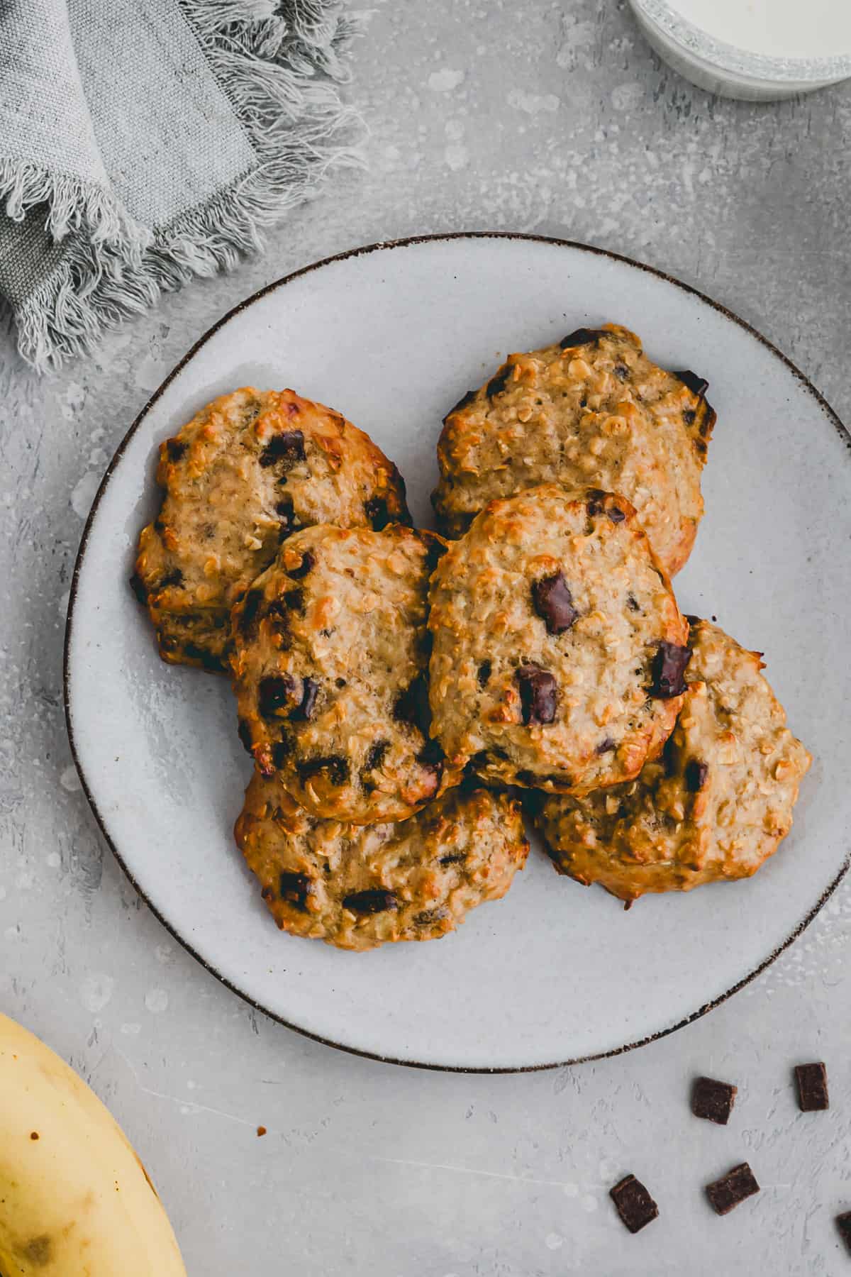 protein oatmeal cookies with chocoalte chips and banana on a plate