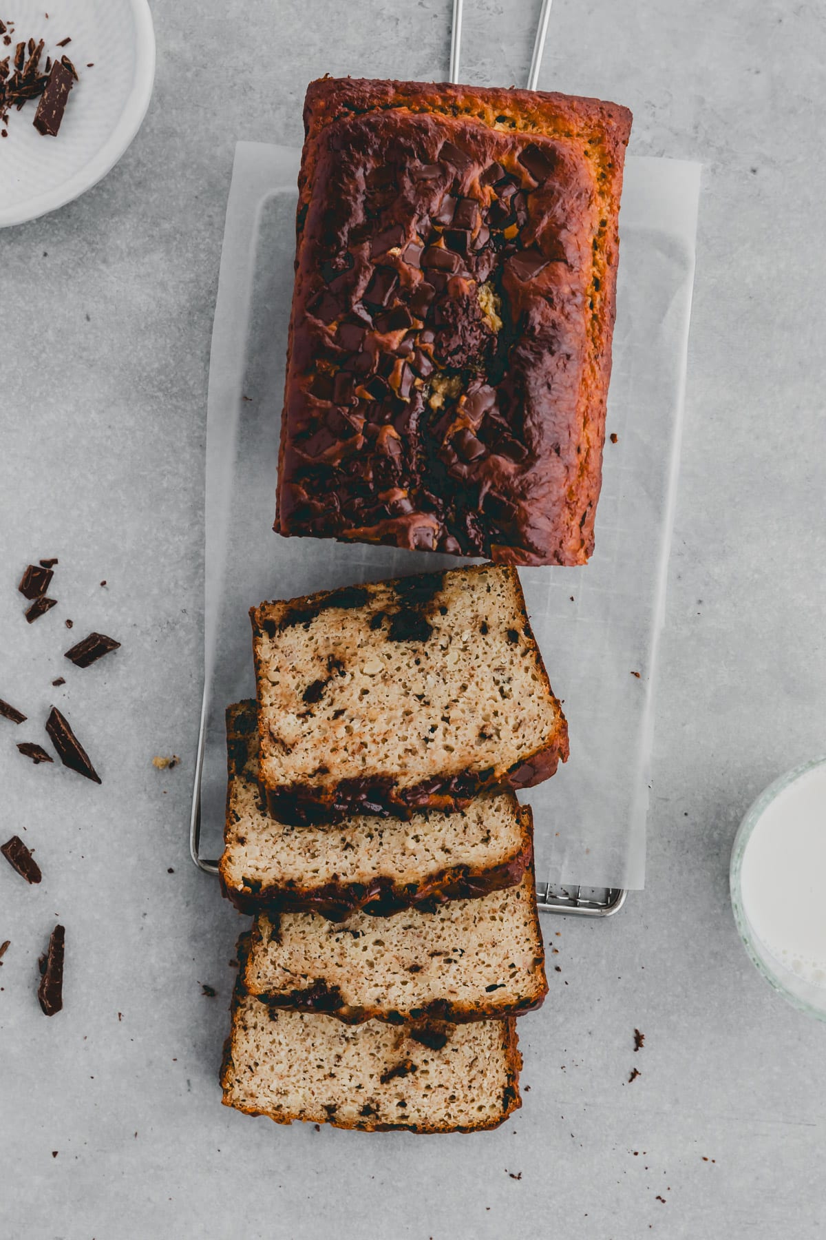 a loaf of banana bread with protein powder on a wire rack