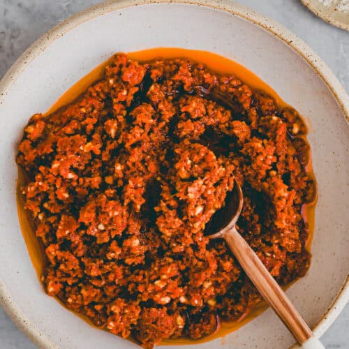pesto rosso in einer schale mit einem löffel