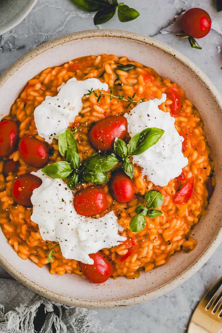 tomato risotto topped with burrata and fresh basil