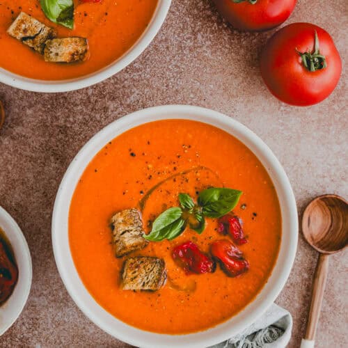 Roasted Tomato Soup served in bowls topped with fresh basil