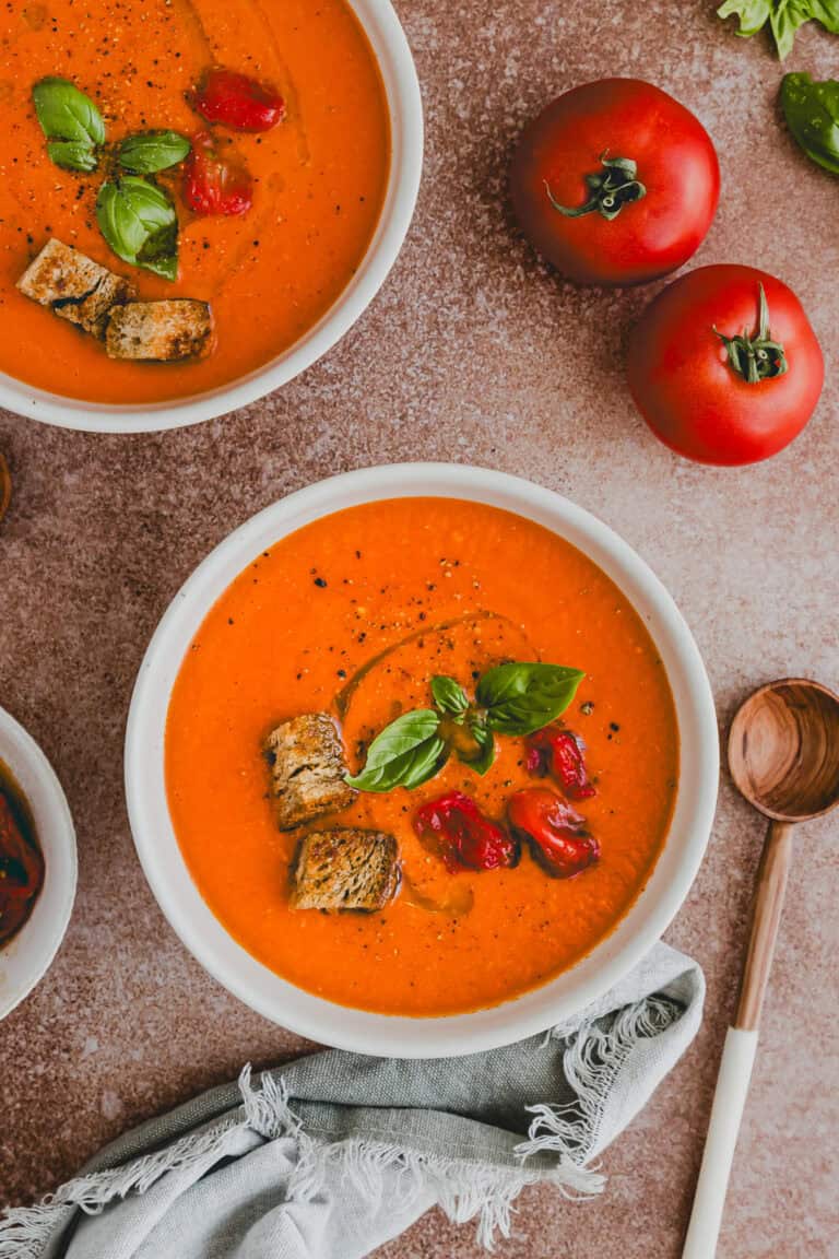 Roasted Tomato Soup served in bowls topped with fresh basil