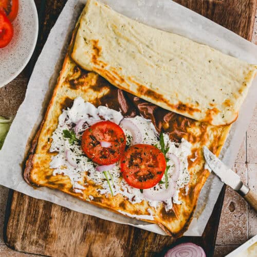 cottage cheese flatbread topped with cream cheese and tomatoes