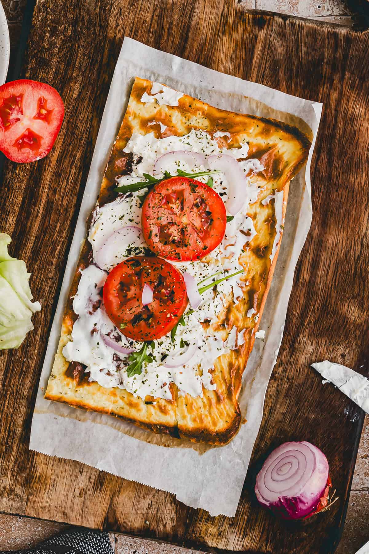 cottage cheese flatbread topped with cream cheese and tomatoes