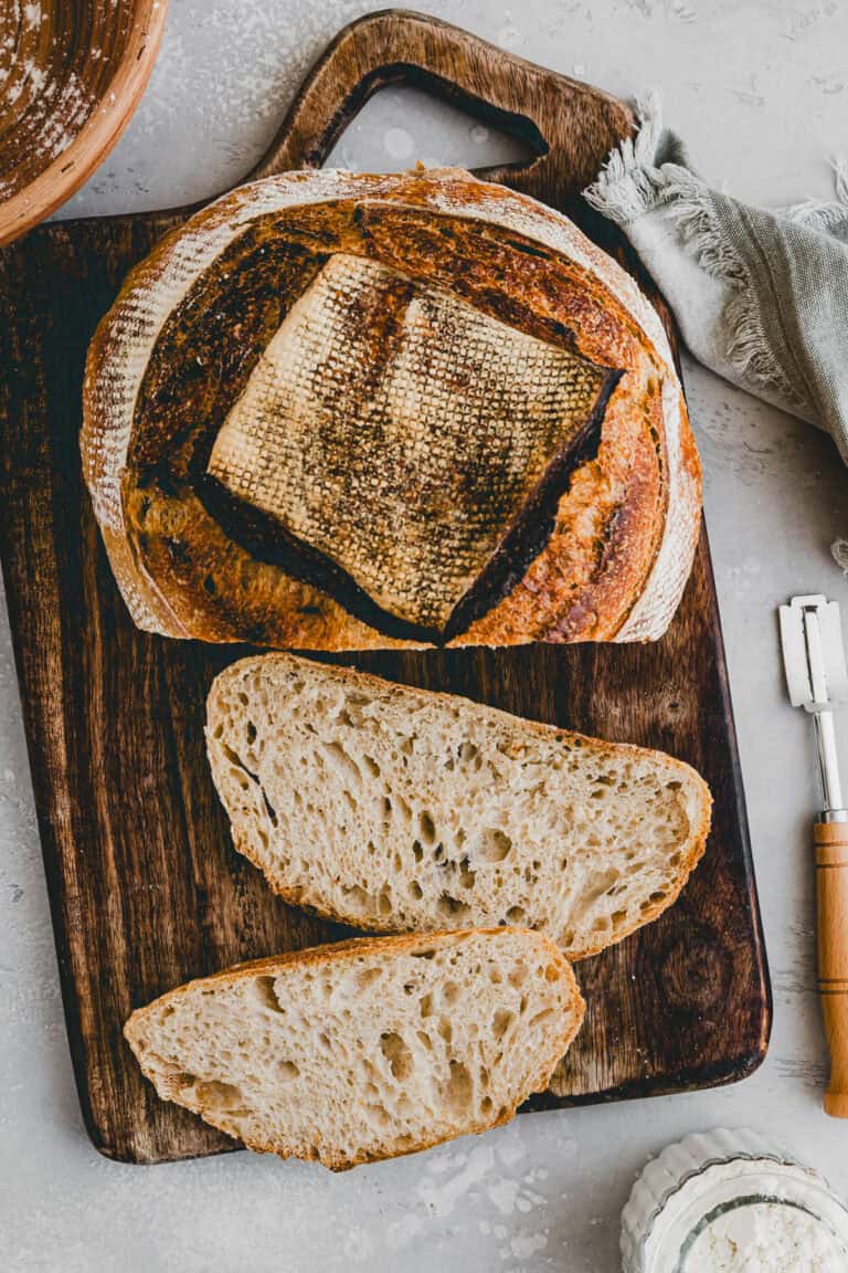 sliced artisan sourdough bread on a chopping board