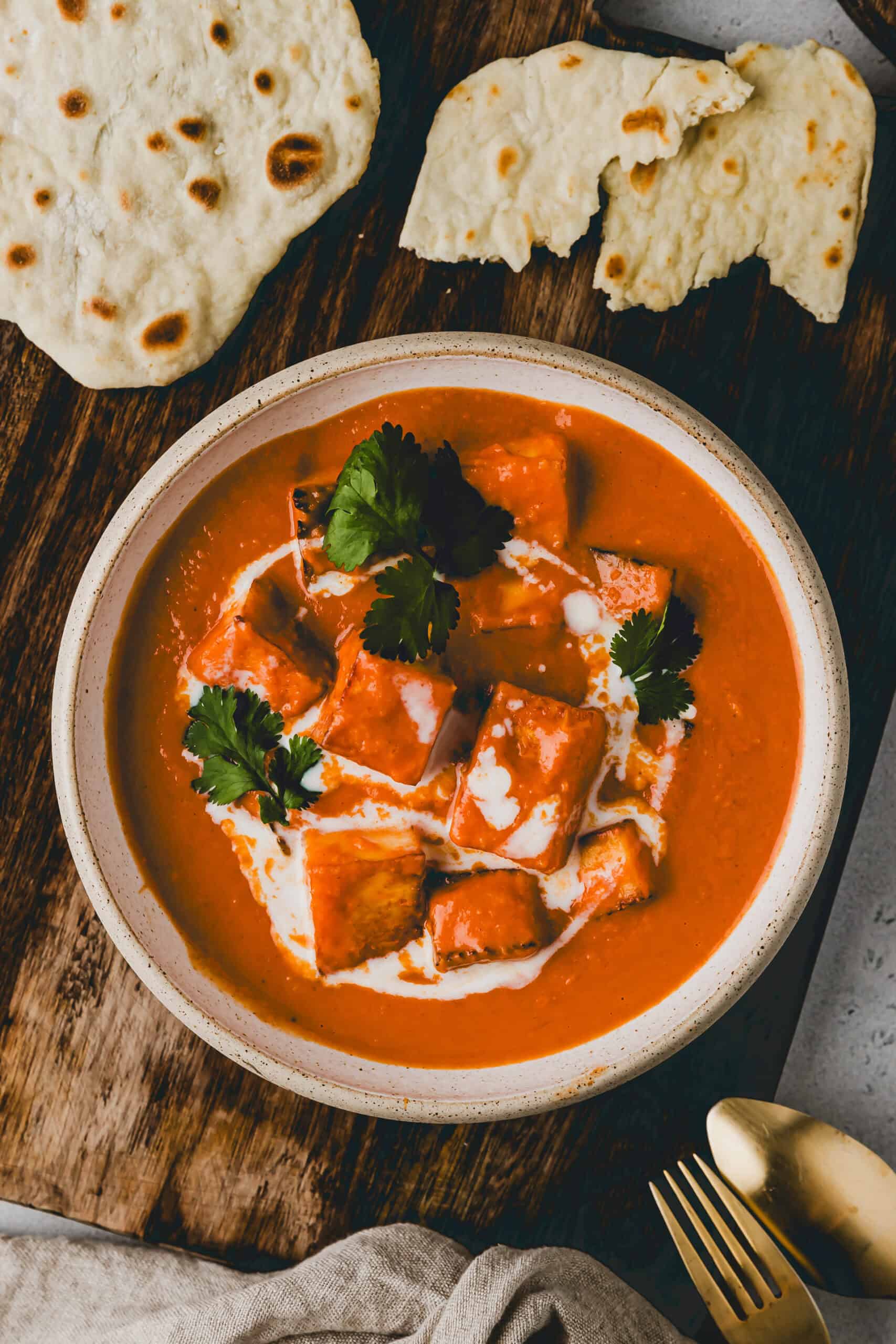 indisches paneer butter masala in einer schüssel serviert mit naan brot