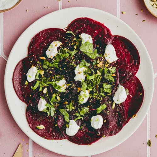 beet carpaccio with goat cheese on a serving platter