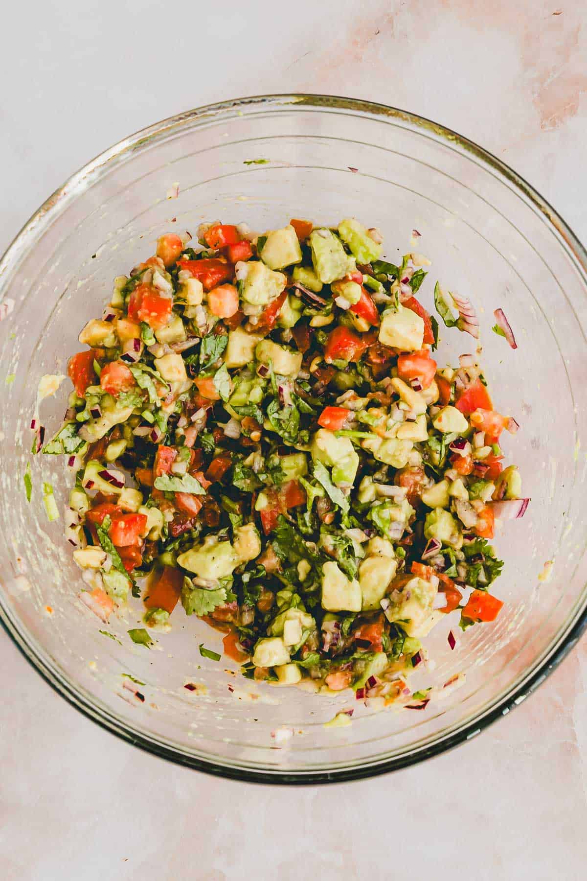 pico de gallo with avocado in a glass bowl