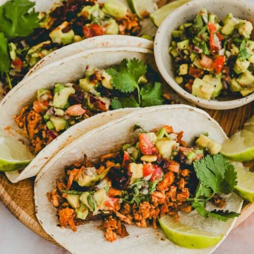 shredded tofu tacos with avocado pico de gallo served on a plate