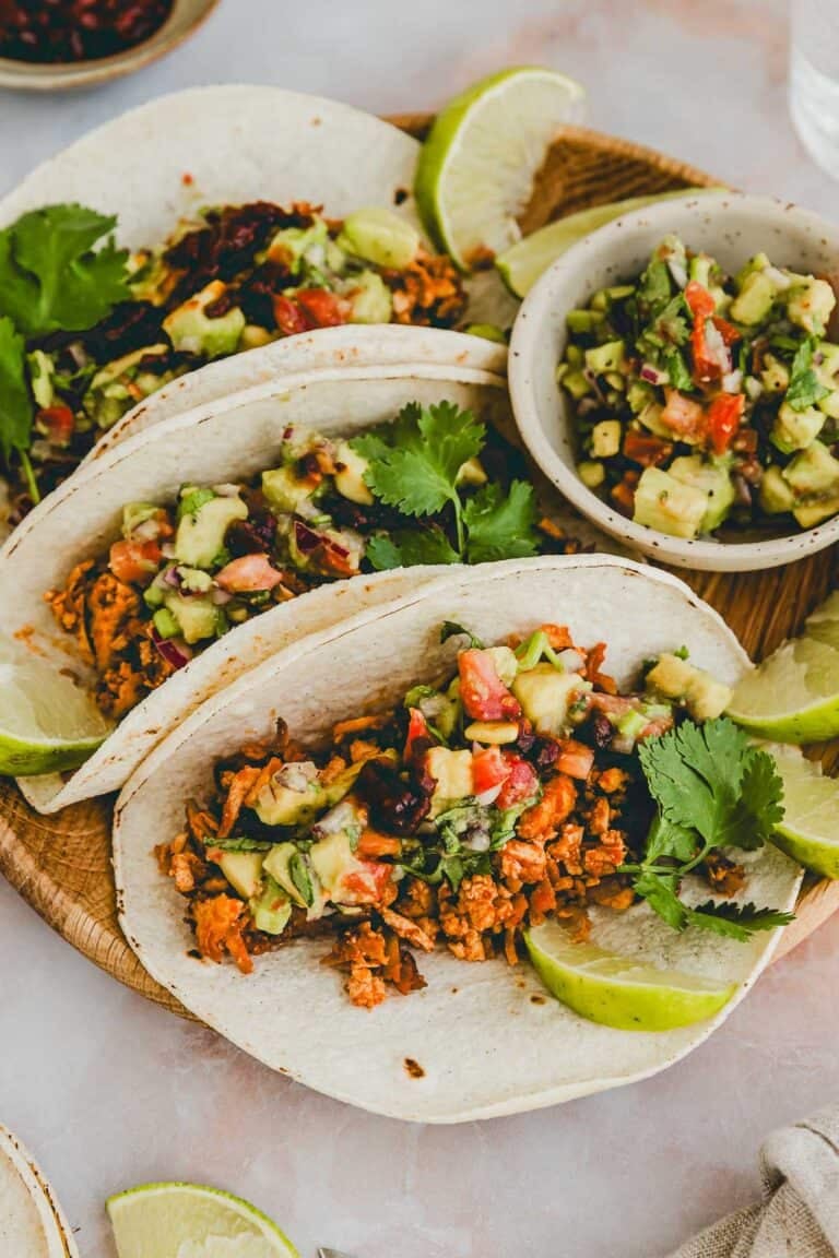 shredded tofu tacos with avocado pico de gallo served on a plate