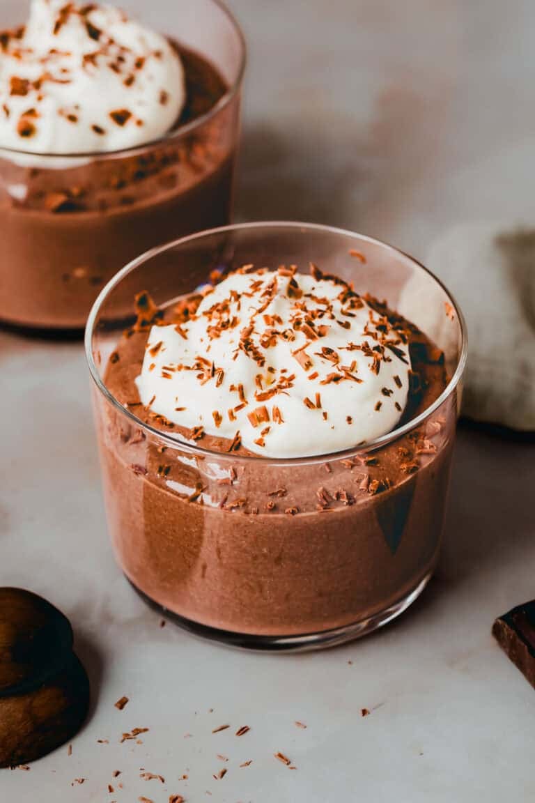 Protein Chocolate Mousse with cottage cheese in a dessert glas topped with whipped cream